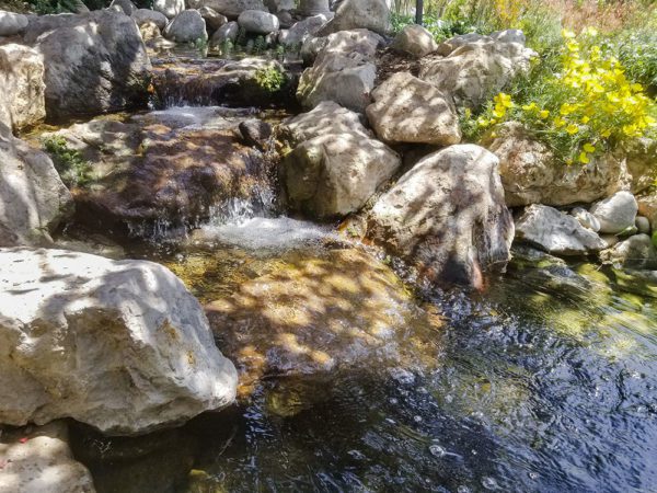 A water streaming down with rocks